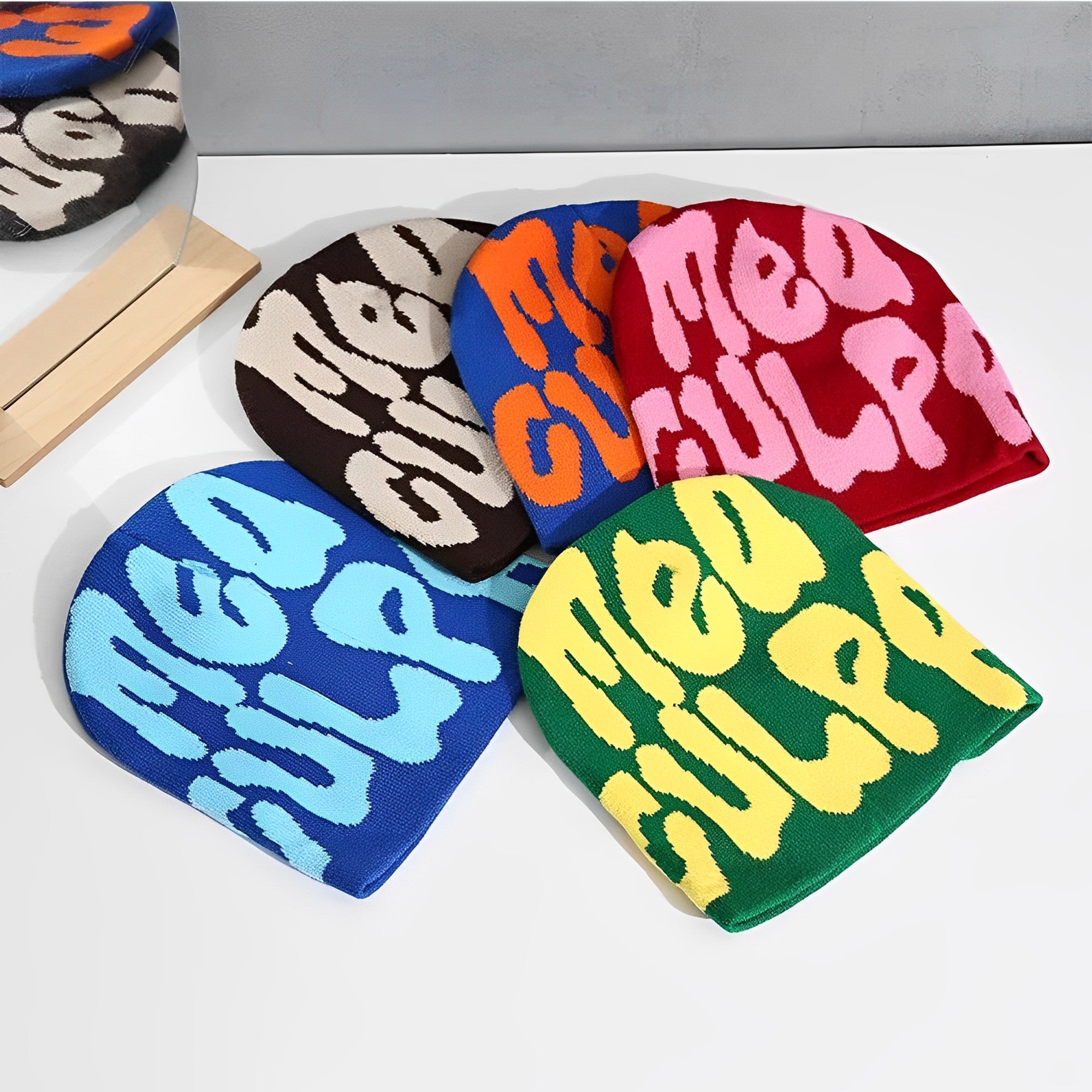 This picture shows mea culpa beanies in various colors.